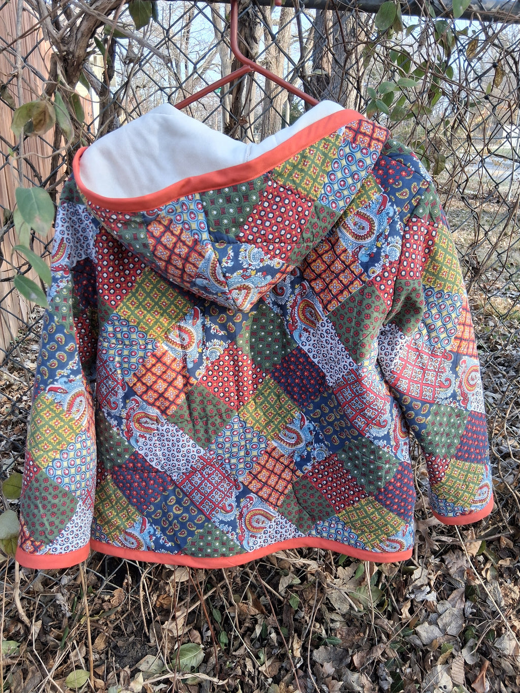 Orange, horseshoe print quilt coat